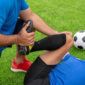 footballer-wearing-blue-shirt-black-pants-injured-lawn-during-racecompresssssss
